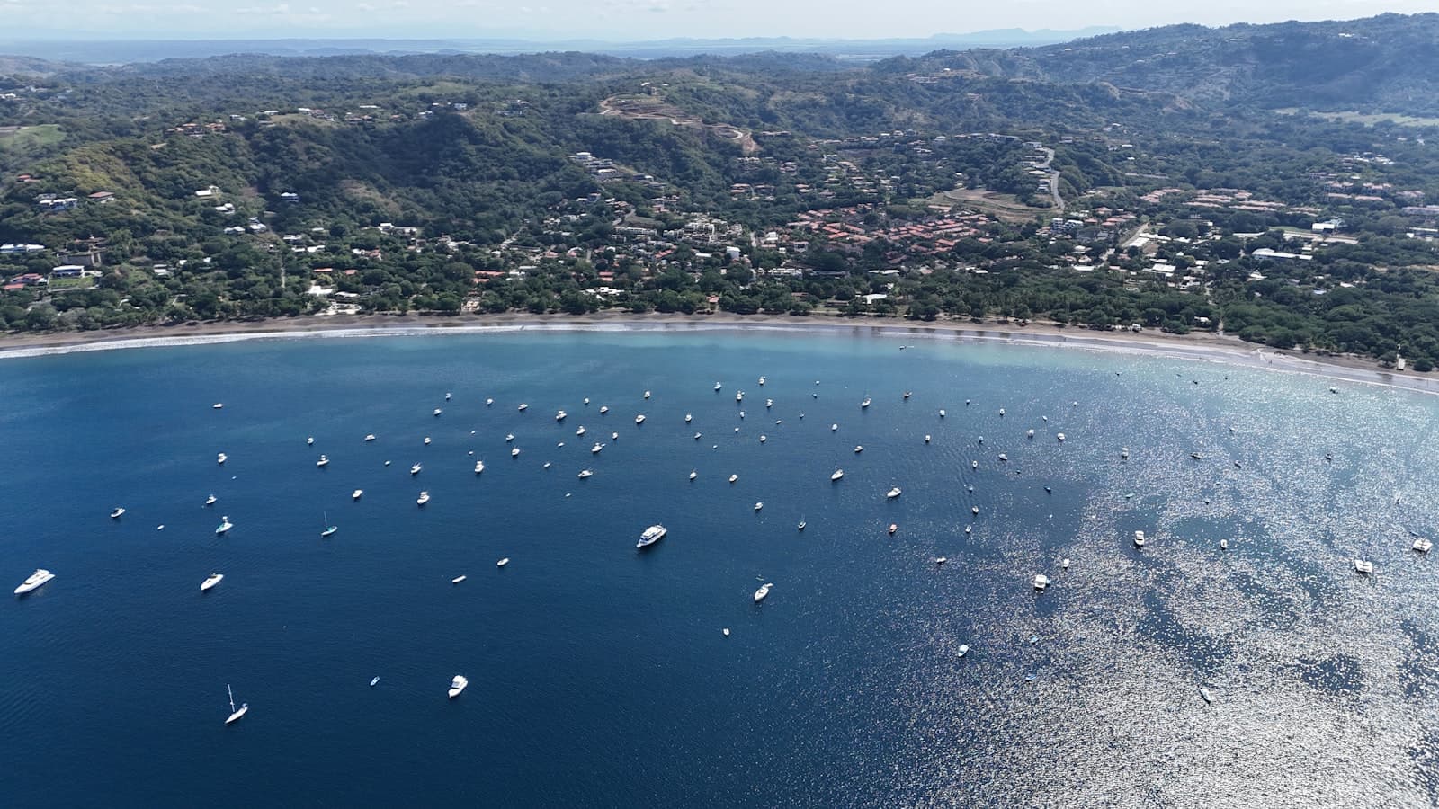 Anchored boats in the white-sand bay at Playa Flamingo