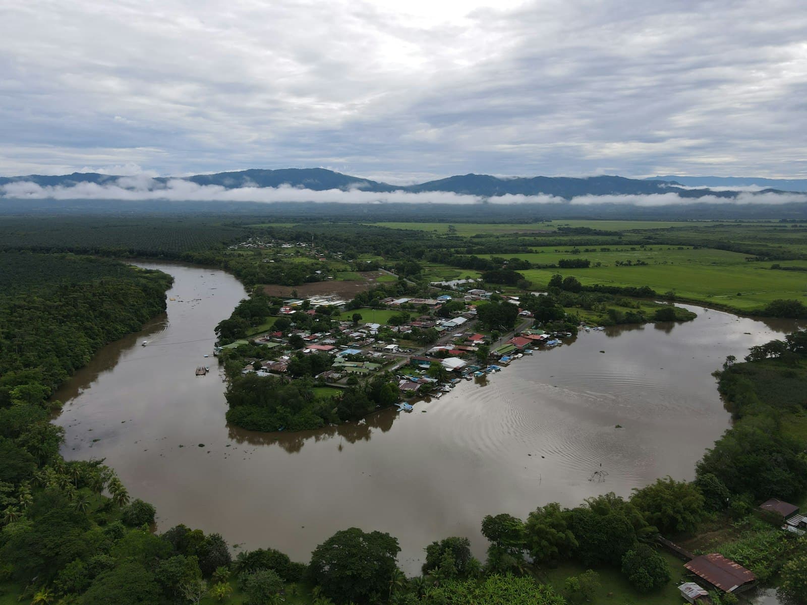 Rainforest river in Costa Rica's southern zone, misty mountains behind